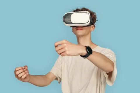Freestyle. Man in vr headset standing isolated on gray playing game driving Stock Photos