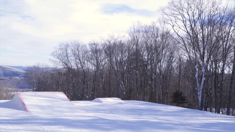 Freestyle Skier does Backflip off Jump at Mountain in Vermont Stock Footage 129457608