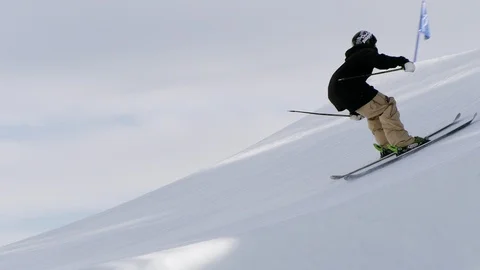 Freestyle skier jumping and spinning off of a jump in the terrain park Video stock 113201670