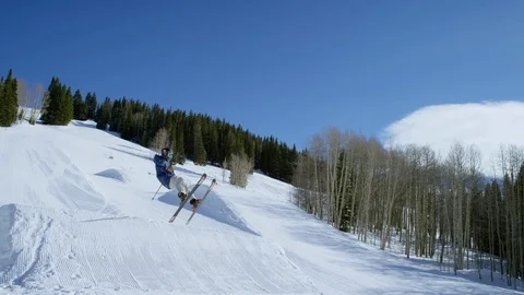 Freestyle skier performing a 540 spin off of a jump Stock Footage 113264106