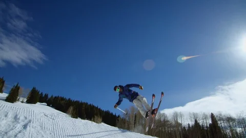 Freestyle skier performing a 720 spin off of a jump Stock Footage 113264054