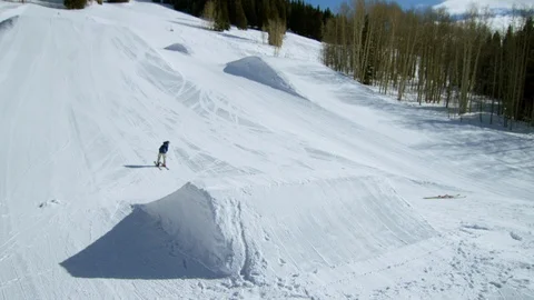 Freestyle skier performing a flip and spin off of a jump in the terrain park Stock Footage 113263523
