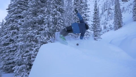 Freestyle Skier Performs Hand Drag 180 In Powder Stock Footage 121428748