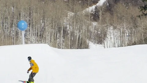 Freestyle snowboarder jumping over obstacle in terrain park Stock Footage 113200719