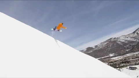 Freestyle snowboarder landing a backflip off of a halfpipe Stock Footage 113199228