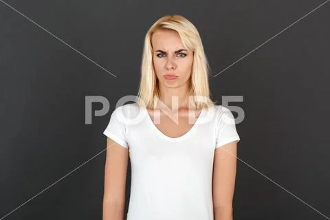 Freestyle. Woman standing isolated on black wall pouting lips unhappy Stock Photos