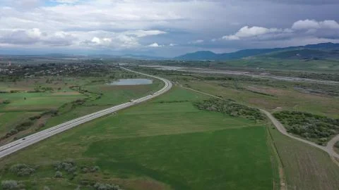 Freeway among green fields Stock Photos