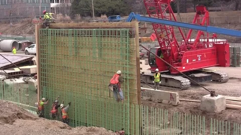 Freeway Construction Workers build retaining wall Stock Footage 105606866