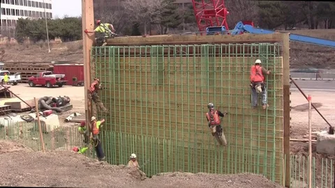 Freeway construction workers climb forms Video stock 105606919