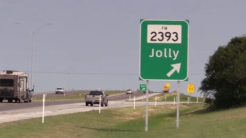 Freeway exit sign for Jolly, Texas Stock Footage 80525404