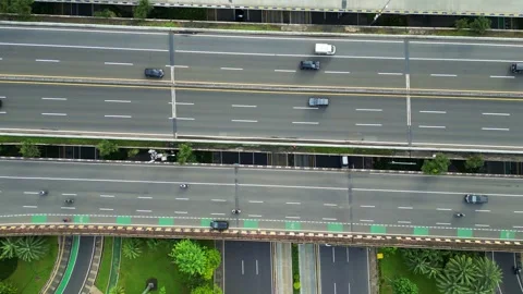 A freeway with a large bridge over it and a city in the background Stock Footage 305833281