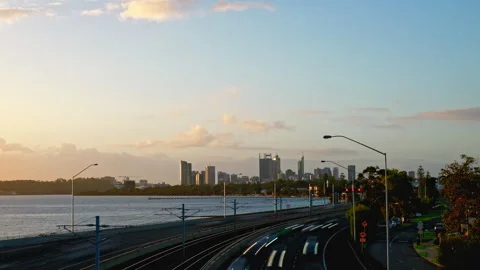 Freeway timelapse as golden rays bathe city and river. Colourful cloudy sky Stock-Footage 278949483