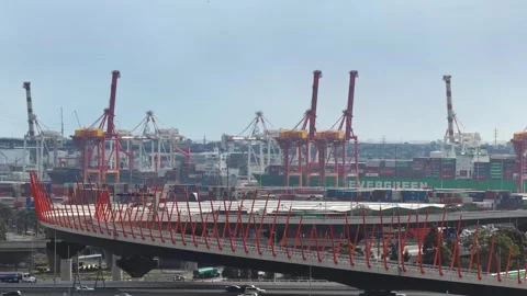 Freeway traffic and cranes around a city port Stock Footage 325276646