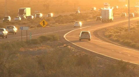Freeway traffic driving toward bright sunset timelapse Stock Footage 61221131