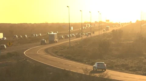 Freeway traffic driving toward bright sunset timelapse Stock Footage 61221311
