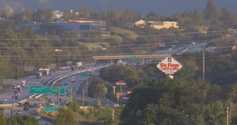 Freeway traffic past Six Flags Magic Mountain in Santa Clarita, California Stock-Footage 201026110
