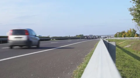 Freeway traffic view from guard rail Stock Footage 56688617