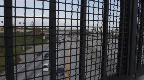 Freeway View through Fence Line Stock Footage 50232936