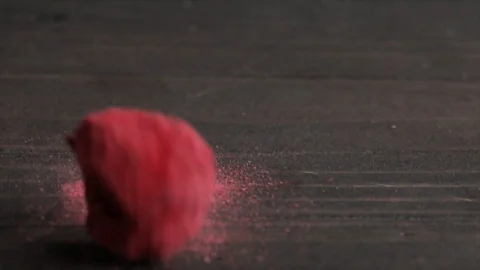 Freeze-Dried Raspberry Falling onto a Dark Table Closeup No. 2 Stock Footage 99162894