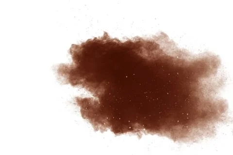 Freeze motion of brown powder exploding. Abstract design of color powder. 库存照片