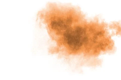 Freeze motion of brown powder exploding. Abstract design of color powder. 库存照片