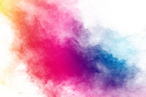 Freeze motion of color powder exploding on white background. Stock Photos