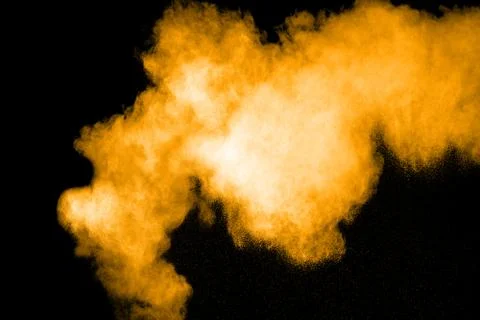 Freeze motion of gold powder exploding. Stock Photos