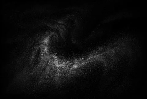 Freeze motion of white powder exploding, isolated on black background. Stock Photos