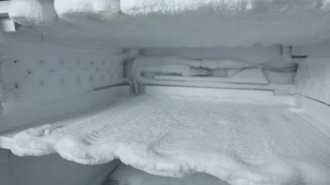 Freezer defrosting process showing gradual removal of ice buildup with visible Stock Footage 325045974