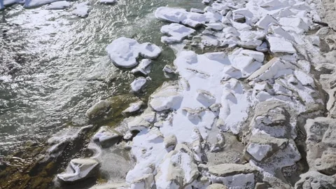 Freezing cold water flowing in small town or village river or stream with snow Stock Footage 319066653