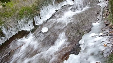Freezing flowing stream in winter Stock Footage 45587515