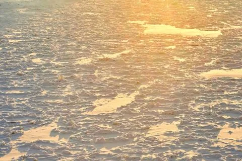 Freezing river in the rays of the evening sun Stock Photos