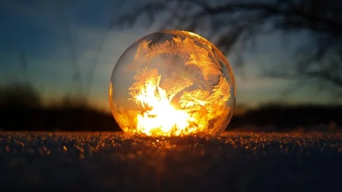 Freezing soap bubble against the background of the sun 4k Stock Footage 255953421