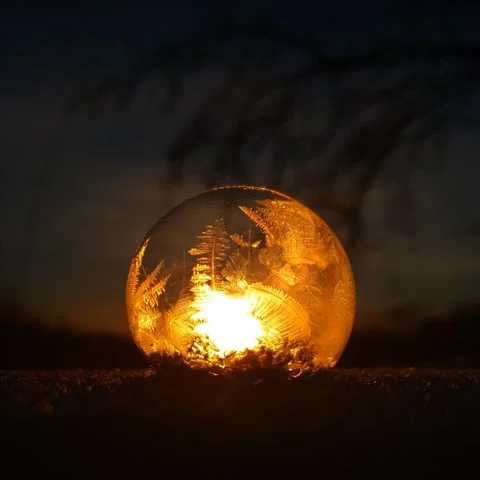 Freezing soap bubble against the background of the sun 4k Stock Footage 255954528