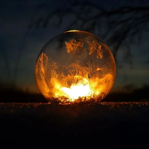 Freezing soap bubble against the background of the sun 4k Stock Footage 255954592