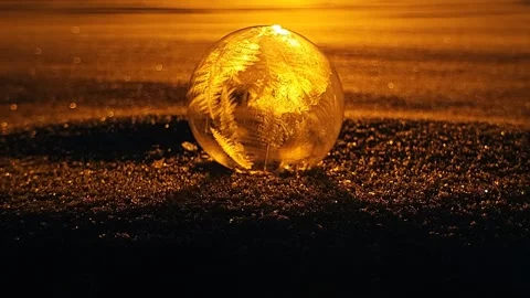 Freezing soap bubble against the background of the sun 4k Stock Footage 255956927