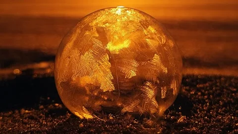 Freezing soap bubble against the background of the sun 4k Stock Footage 255956928