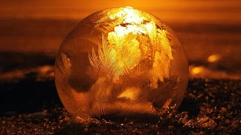 Freezing soap bubble against the background of the sun 4k Stock Footage 255956940