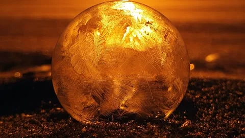 Freezing soap bubble against the background of the sun 4k Stock Footage 255956941