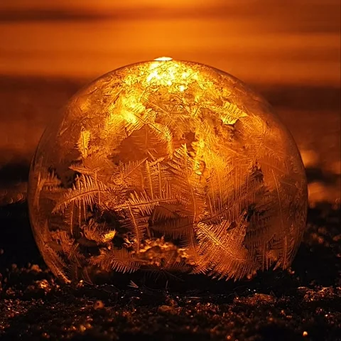 Freezing soap bubble against the background of the sun 4k Video stock 255956967