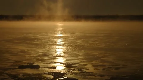 Freezing of a wide river with steam in the sunlight Stock Footage 256606704