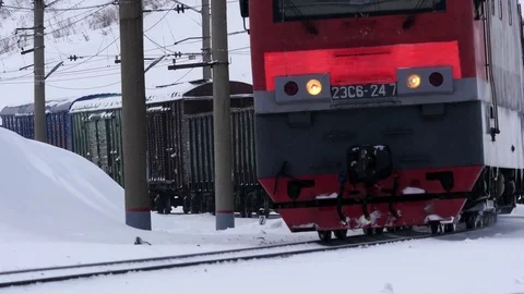 Freght train in Siberian snowfall long focus shot Stock Footage 70791074