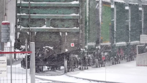 Freght train in Snowstorm long focus Stock Footage 70791085