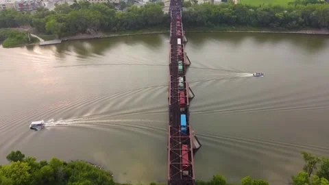 Freight Cargo Train Crossing Historic Truss Bridge and River Wake Trails Aer Video stock 347537009