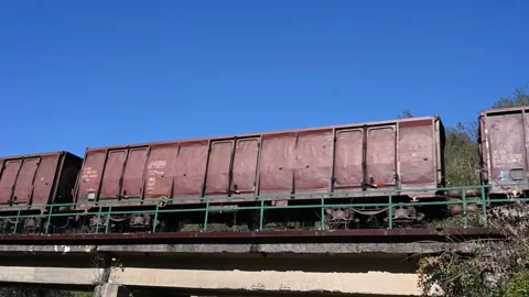 Freight cars moving fast on the railway track. Train on the bridge. Stock Footage 255331053