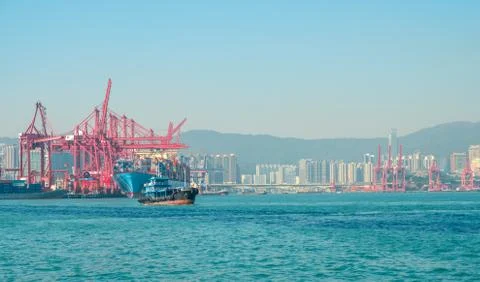Freight container ship and cranes at  harbour logistics centre in Hong Kong Stock Photos