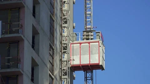 Freight elevator at the construction site of a tall building rides up and down Stock Footage 172484831