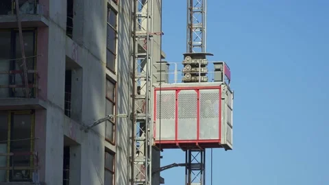 Freight elevator at the construction site of a tall building rides up and down Stock Footage 172484911