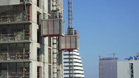 Freight elevator at the construction site of a tall building rides up and down Stock Footage 172485002