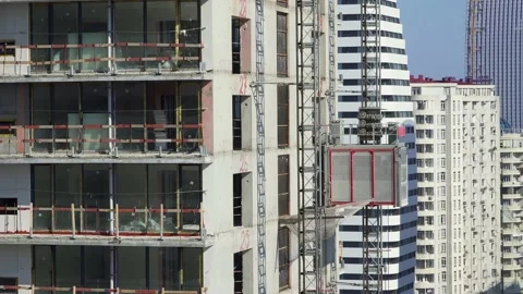 Freight elevator at the construction site of a tall building rides up and down Video stock 172485050